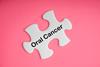 Oral,Cancer,Text,With,White,Jigsaw,Puzzle,On,Pink,Background.