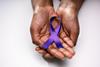 Human,Hand,Showing,Violet,Ribbon,To,Support,Pancreatic,Cancer,Awareness