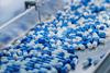 Blue,Capsules,Are,Moving,On,Conveyor,At,Modern,Pharmaceutical,Factory.