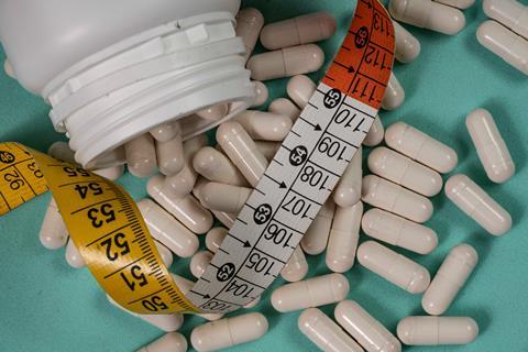 Medicine,Jar,With,White,Pills,And,A,Measuring,Tape,Symbolizing