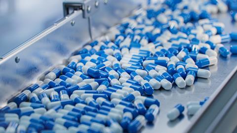 Blue,Capsules,Are,Moving,On,Conveyor,At,Modern,Pharmaceutical,Factory.