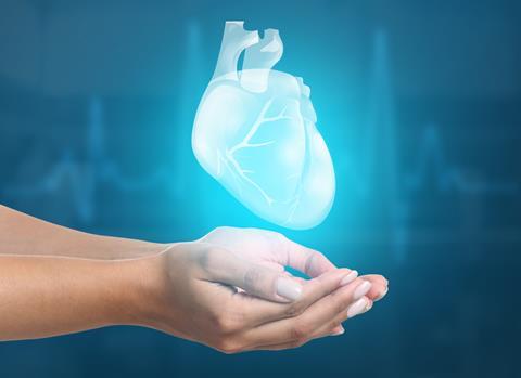 Female,Hands,With,Heart,On,Blue,Background.,Cardiology,Concept.