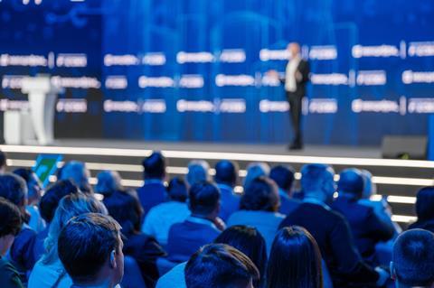 Blurred,View,Of,A,Speaker,At,A,Professional,Conference,With